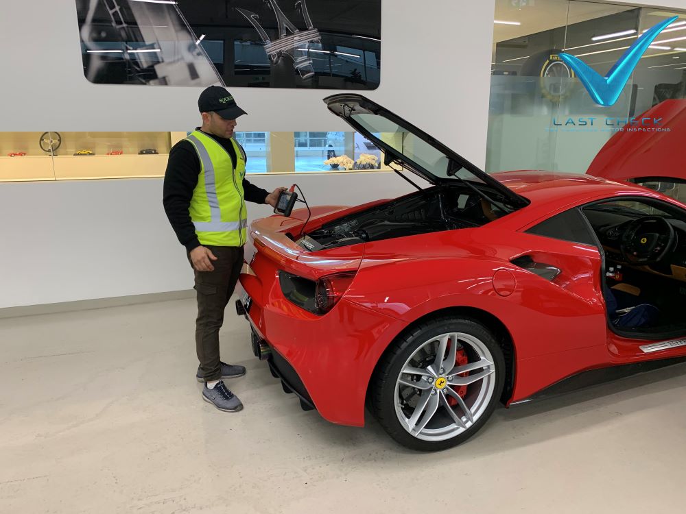 Last Check Ferrari Specialist Inspecting A Red Ferrari